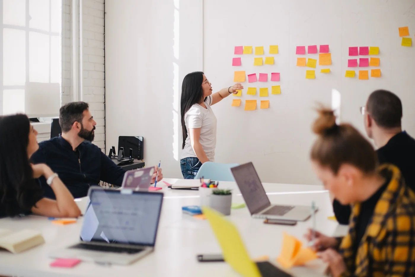 A communications team planning at a whiteboard