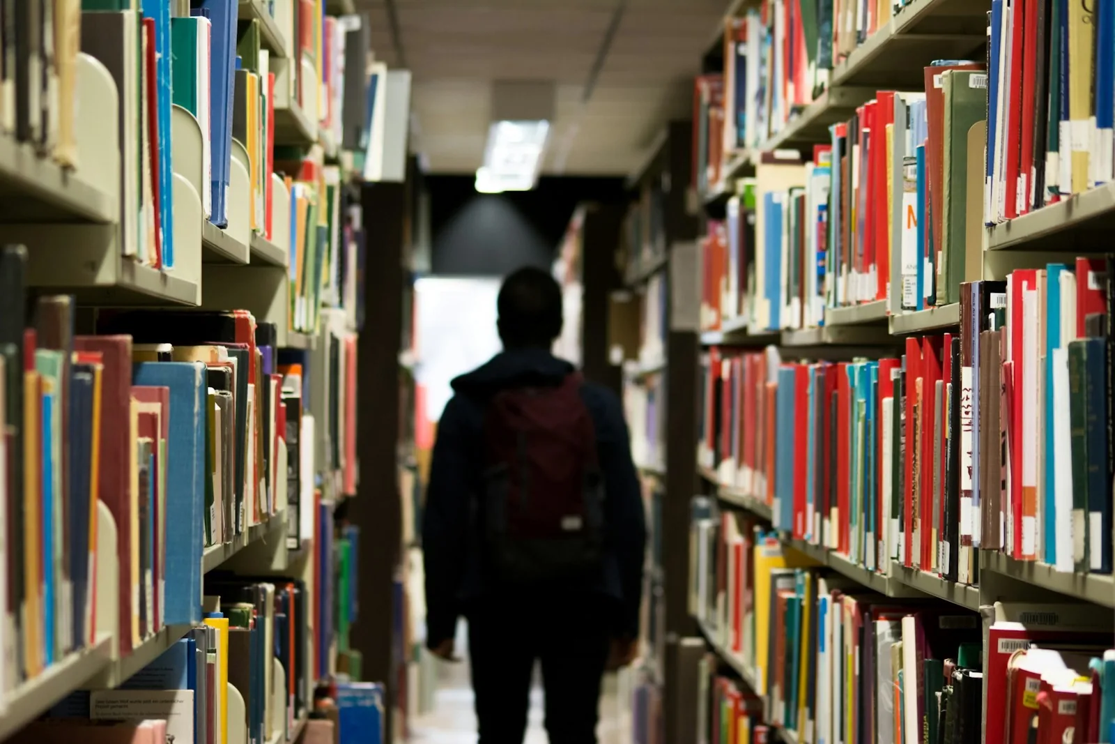 A university library aisle with full bookshelves